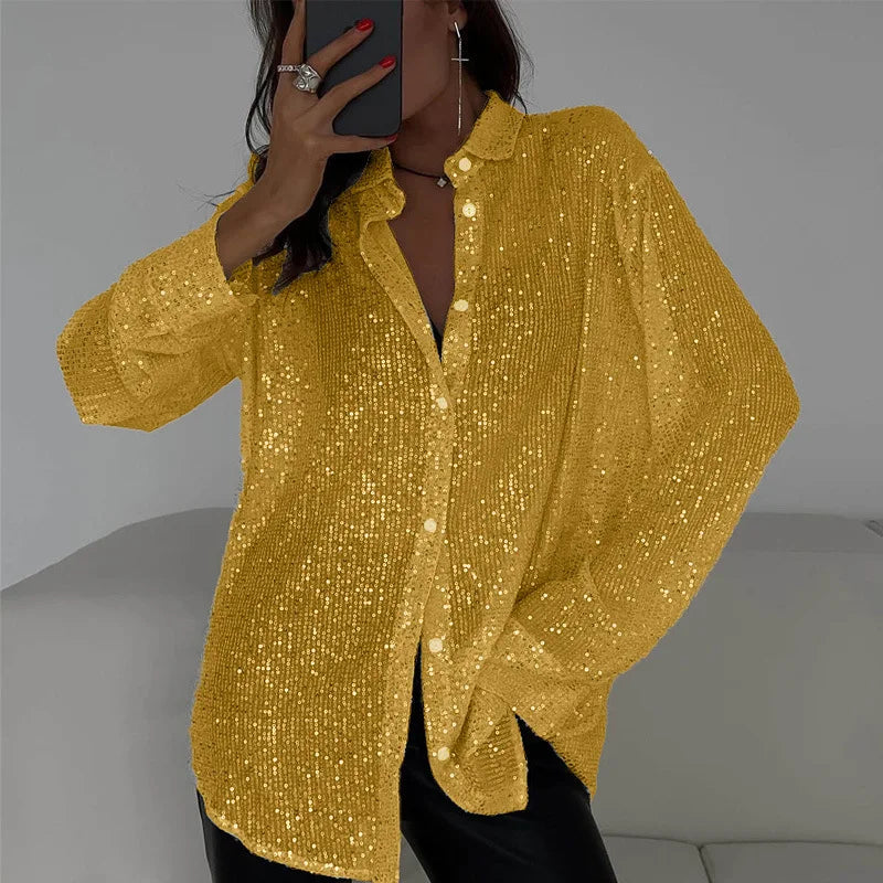 Camisa de lentejuelas de manga larga de BB Bellezachic, con detalles brillantes y estilo elegante, sobre fondo neutro.